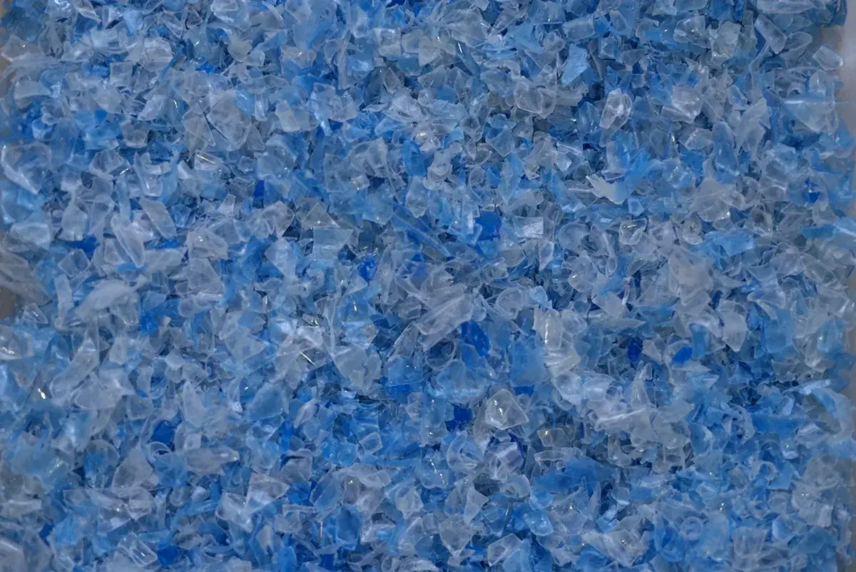 Transparent/light blue rPET flakes close-up